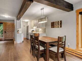 Experience rustic charm and modern convenience in this inviting dining area, featuring a sturdy wooden table and chairs perfect for family meals.