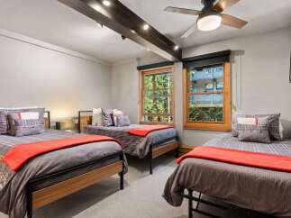 This charming bedroom features three twin beds, perfect for accommodating family or guests.