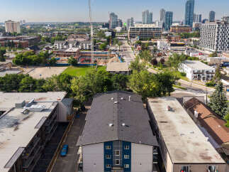 Discover modern living in this vibrant urban neighborhood, featuring a sleek apartment building with contemporary design elements.