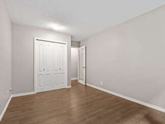 Discover this inviting bedroom featuring a spacious double-door closet, perfect for ample storage.