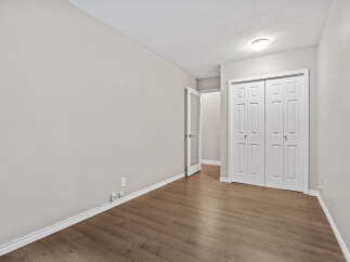 Step into this inviting room featuring a spacious closet with double doors, perfect for ample storage.