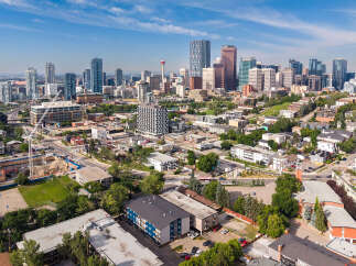 Discover this vibrant urban landscape featuring a mix of modern high-rises and charming residential areas, perfect for city living.