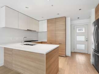 Experience modern living in this sleek kitchen featuring a spacious island with a double sink and a contemporary faucet.