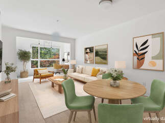 Experience modern living in this beautifully staged living and dining area, featuring a comfortable sofa, accent chairs, and a round dining table perfect for intimate gatherings.