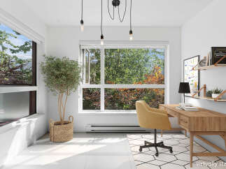 Bright and airy home office featuring a large window with lush green views, a modern wooden desk, and a comfortable yellow accent chair.