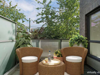 Enjoy your morning coffee or evening drinks on this charming balcony, perfect for relaxation.