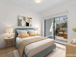 Experience modern comfort in this beautifully staged bedroom, featuring a plush bed with accent pillows and a cozy throw.