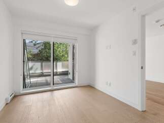 Step into this bright and airy room, featuring a large sliding glass door that opens to a private balcony, perfect for enjoying the outdoors.