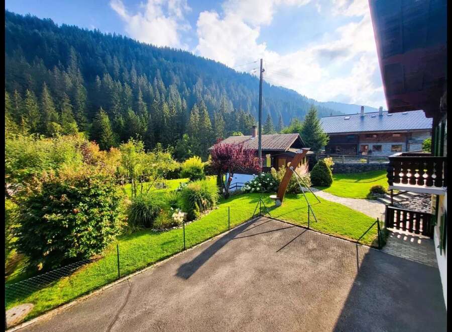 Nestled amidst a lush green landscape with a majestic mountain backdrop, this charming property offers a serene escape.