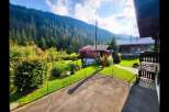 Nestled amidst a lush green landscape with a majestic mountain backdrop, this charming property offers a serene escape.
