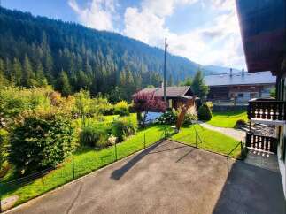 Nestled amidst a lush green landscape with a majestic mountain backdrop, this charming property offers a serene escape.