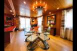 Experience elegant dining in this beautifully appointed space, featuring a stunning glass-top dining table with modern chairs.