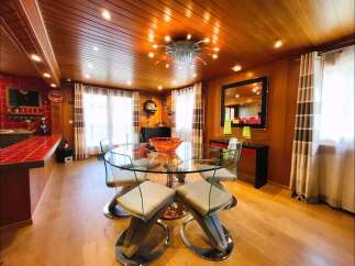 Experience elegant dining in this beautifully appointed space, featuring a stunning glass-top dining table with modern chairs.