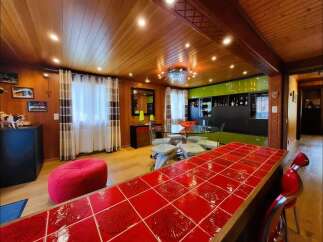 Experience modern living in this stunning home featuring a vibrant red tiled breakfast bar, perfect for casual dining and entertaining.
