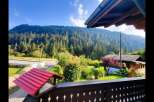 Experience serene mountain living with this charming property nestled amidst a lush evergreen forest.