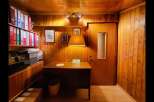 Discover this charming office space featuring warm wood-paneled walls and a cozy desk area, perfect for focused work.