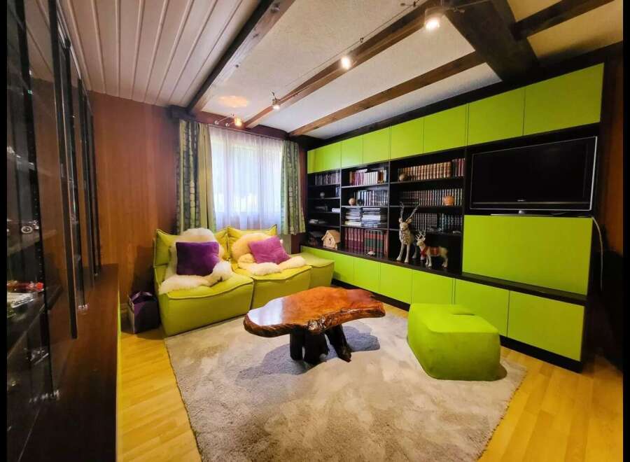 This cozy living room features vibrant lime green modular cabinets and seating, creating a playful and modern aesthetic.