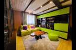 This cozy living room features vibrant lime green modular cabinets and seating, creating a playful and modern aesthetic.