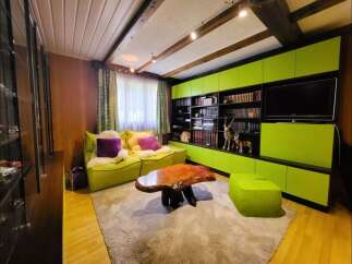 This cozy living room features vibrant lime green modular cabinets and seating, creating a playful and modern aesthetic.