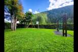 Discover this charming property featuring a lush green lawn perfect for outdoor activities and a dedicated playground area for children's enjoyment.