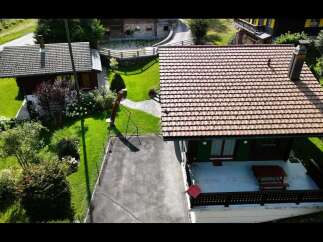 Discover this charming property featuring a well-maintained house with a classic tiled roof and a spacious outdoor patio perfect for relaxation.