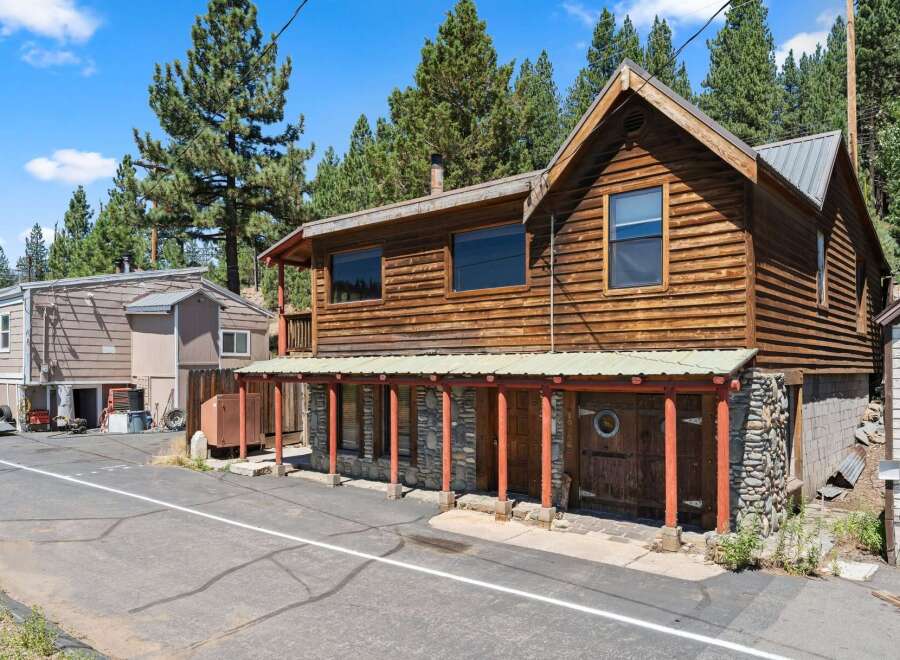 Discover this charming rustic cabin nestled amongst tall pine trees.