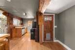 Experience rustic charm in this home featuring exposed wooden beams and a warm, inviting kitchen.