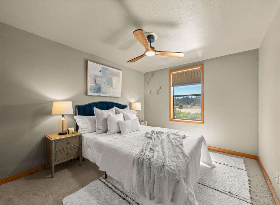 This inviting bedroom features a plush white duvet and a luxurious faux fur throw, creating a cozy and comfortable atmosphere.