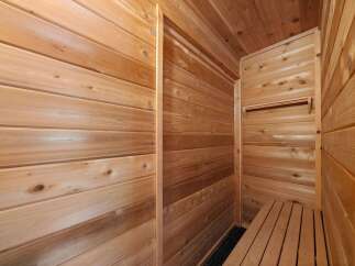Step into tranquility with this exquisite cedar sauna, designed to offer a luxurious and rejuvenating experience.