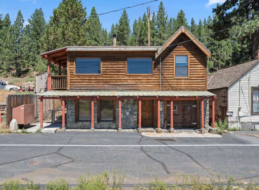 Discover this charming rustic cabin nestled amongst tall pine trees, offering a unique blend of natural beauty and cozy living.