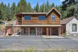 Discover this charming rustic cabin nestled amongst tall pine trees, offering a unique blend of natural beauty and cozy living.