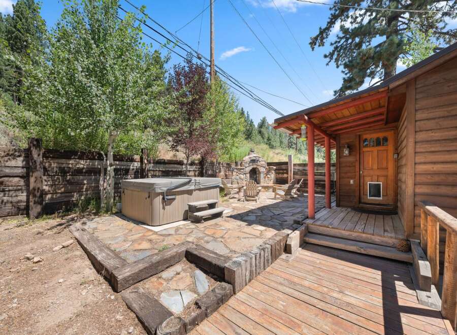 Escape to this charming rustic cabin retreat, featuring a relaxing hot tub perfect for unwinding after a day of adventure.
