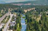 Experience the serene beauty of this riverside property, nestled amidst a lush pine forest.