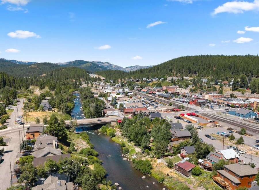 Discover this charming mountain town nestled alongside a scenic river, offering a perfect blend of natural beauty and community living.