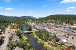 Discover this charming mountain town nestled alongside a scenic river, offering a perfect blend of natural beauty and community living.