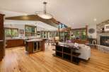Experience open-concept living in this stunning home featuring a gourmet kitchen with a central island and wine fridge, seamlessly flowing into a spacious living area.
