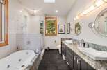 Experience luxury in this stunning bathroom featuring a deep soaking tub and a separate glass-enclosed shower.