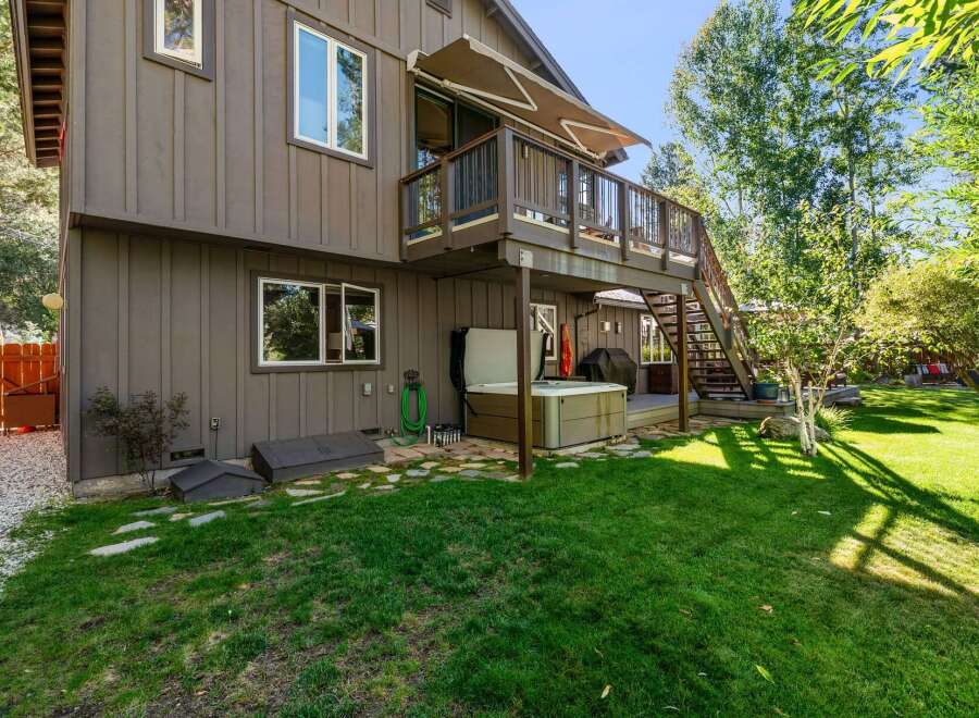 Enjoy outdoor living with this charming home featuring a spacious deck and a relaxing hot tub, perfect for unwinding after a long day.