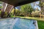 Enjoy ultimate relaxation in this stunning backyard oasis, featuring a bubbling hot tub perfect for unwinding after a long day.