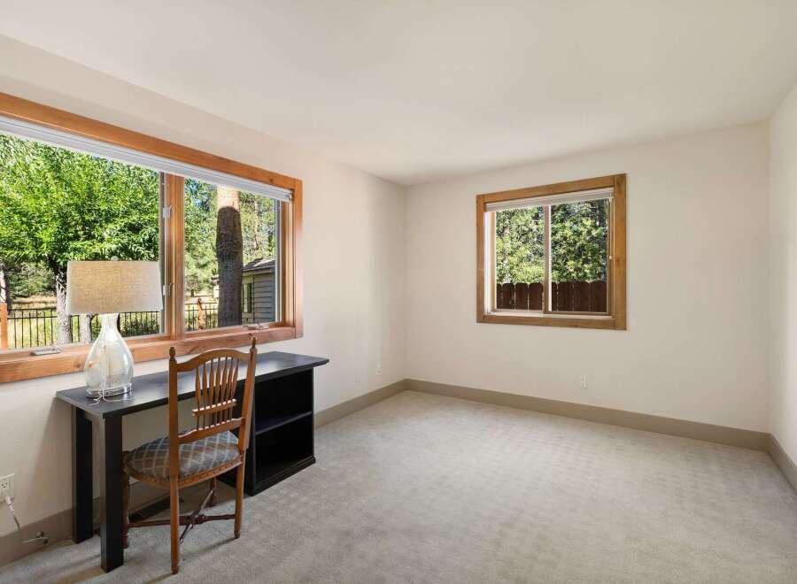 This room features a spacious desk and chair, perfect for a home office or study area.