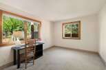 This room features a spacious desk and chair, perfect for a home office or study area.