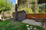 Enjoy the serene backyard oasis featuring a charming shed for storage and a relaxing hammock area perfect for unwinding.
