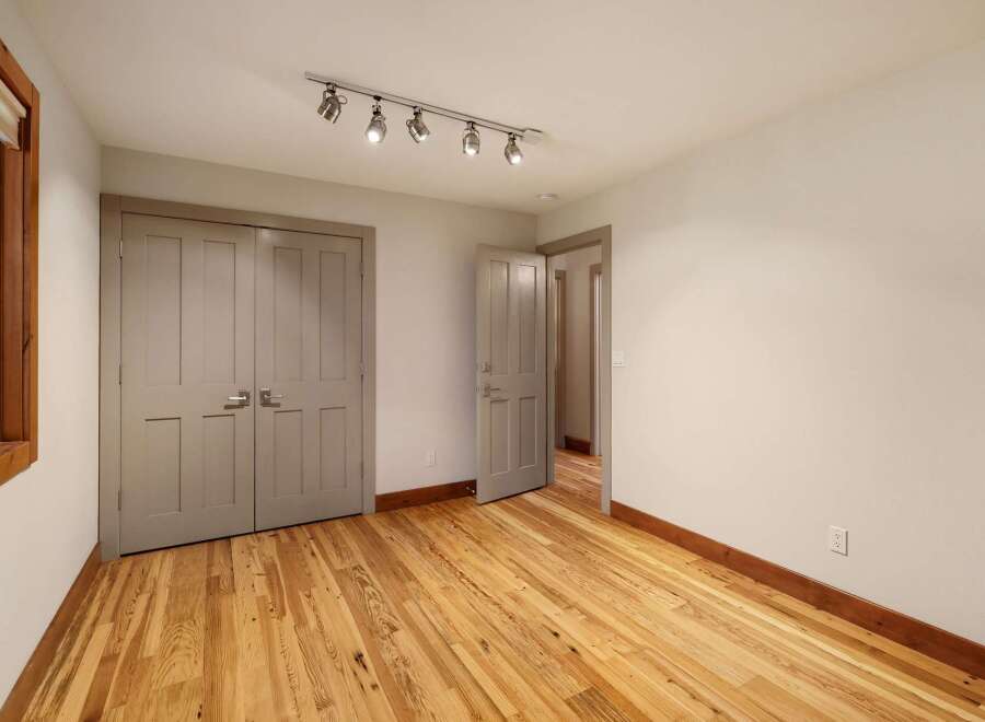 This inviting room features a spacious closet with double doors, perfect for ample storage.