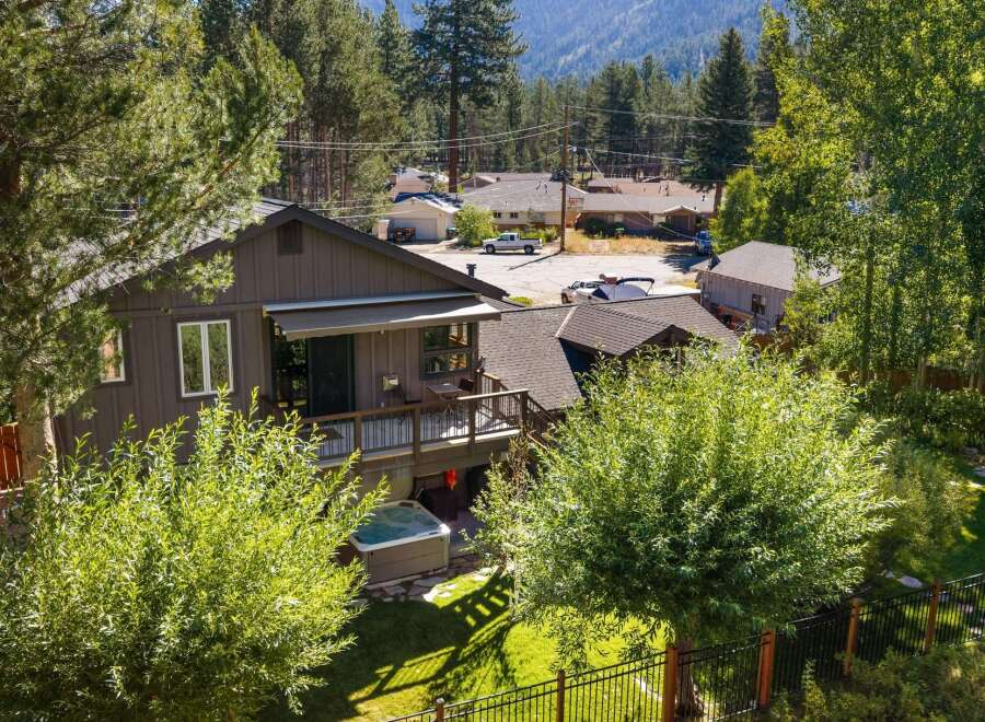 Enjoy outdoor living with this charming home featuring a spacious deck and a relaxing hot tub, perfect for unwinding after a long day.