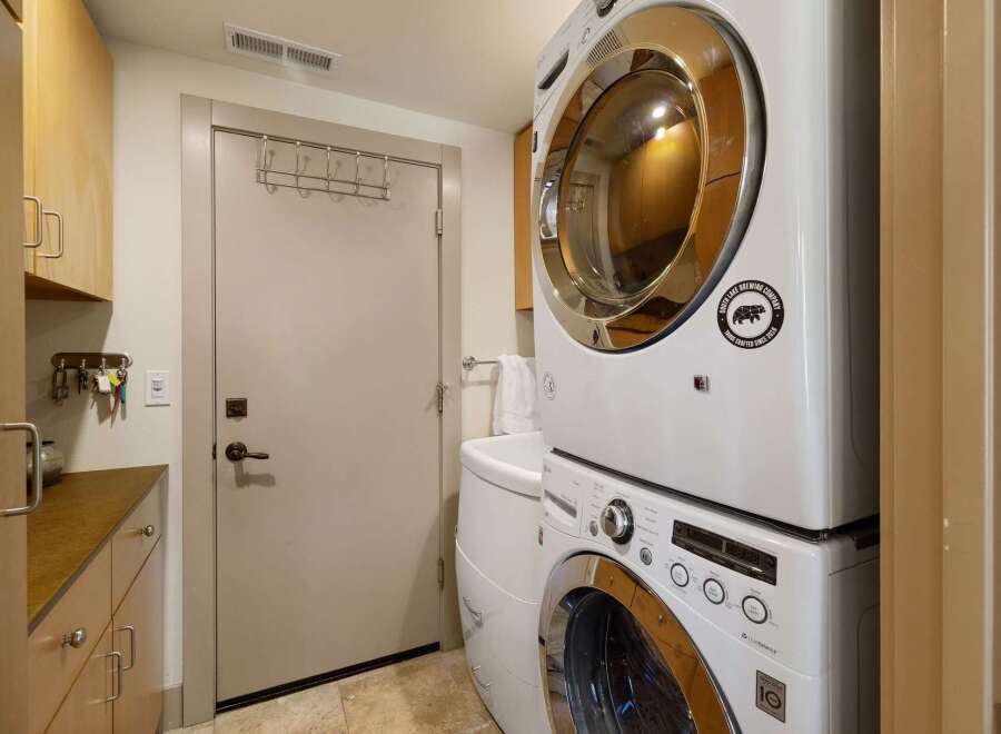 This laundry room features a stacked LG washer and dryer set, perfect for maximizing space.