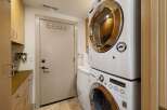 This laundry room features a stacked LG washer and dryer set, perfect for maximizing space.