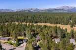 Nestled amidst a dense pine forest, this property offers a serene retreat with stunning mountain views in the distance.