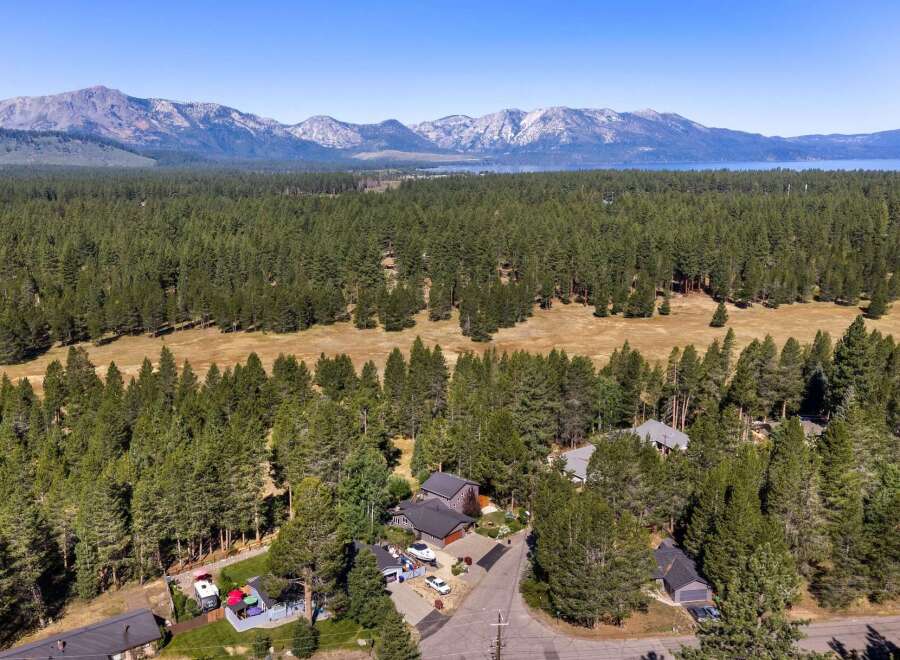 Nestled amidst a dense pine forest, this property offers a serene escape with stunning mountain views in the distance.