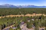 Nestled amidst a dense pine forest, this property offers a serene escape with stunning mountain views in the distance.