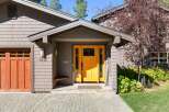 Welcome to this charming home featuring a vibrant yellow front door, perfect for creating a warm and inviting atmosphere.